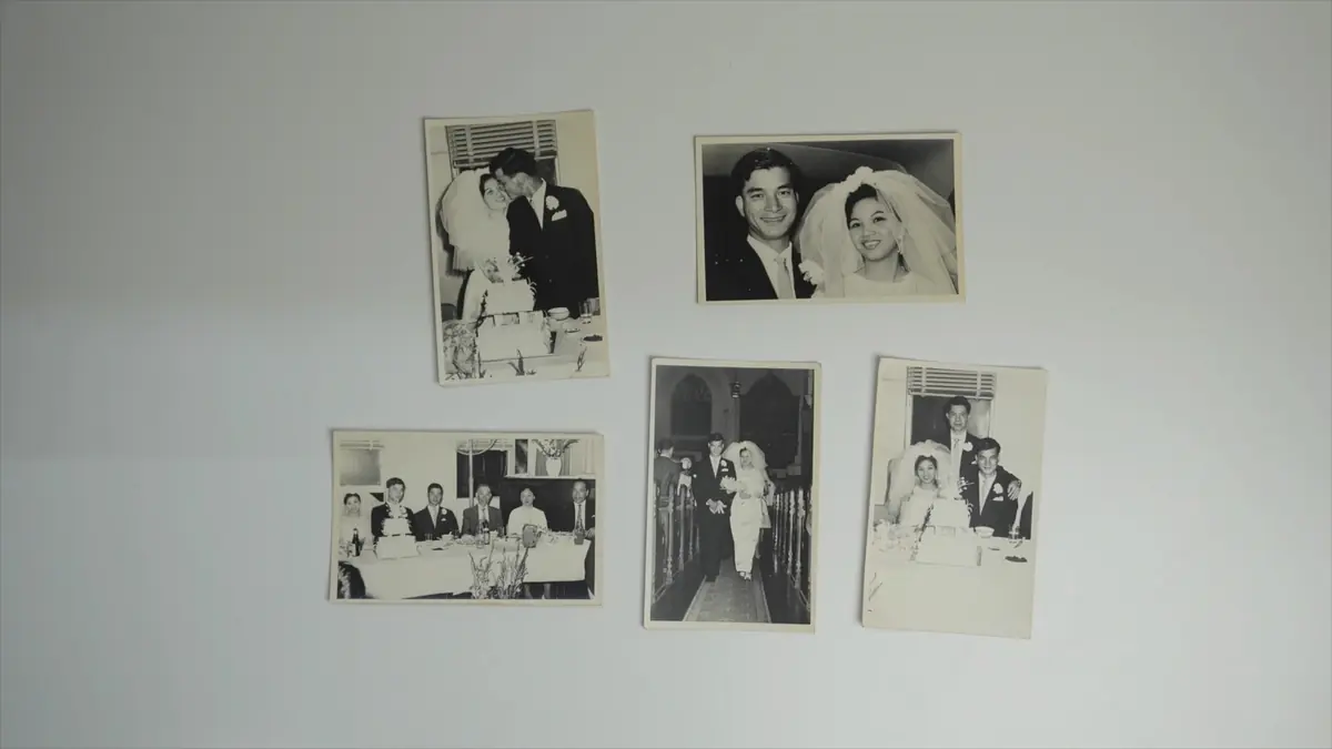 Old family wedding photographs arranged on a wall