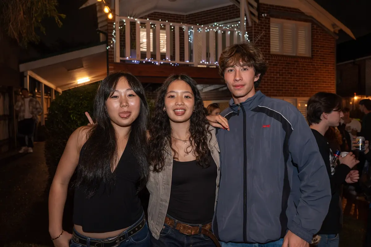 Group photo at a night party outside a house