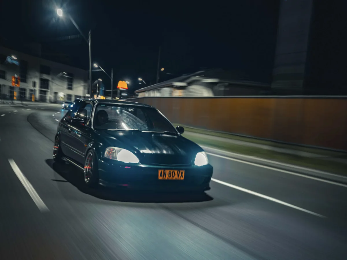 Modified car photographed while driving through city streets at night